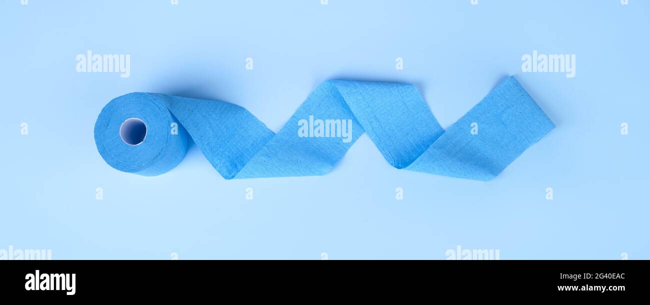 blue roll of toilet paper unrolled on a blue background, hygiene