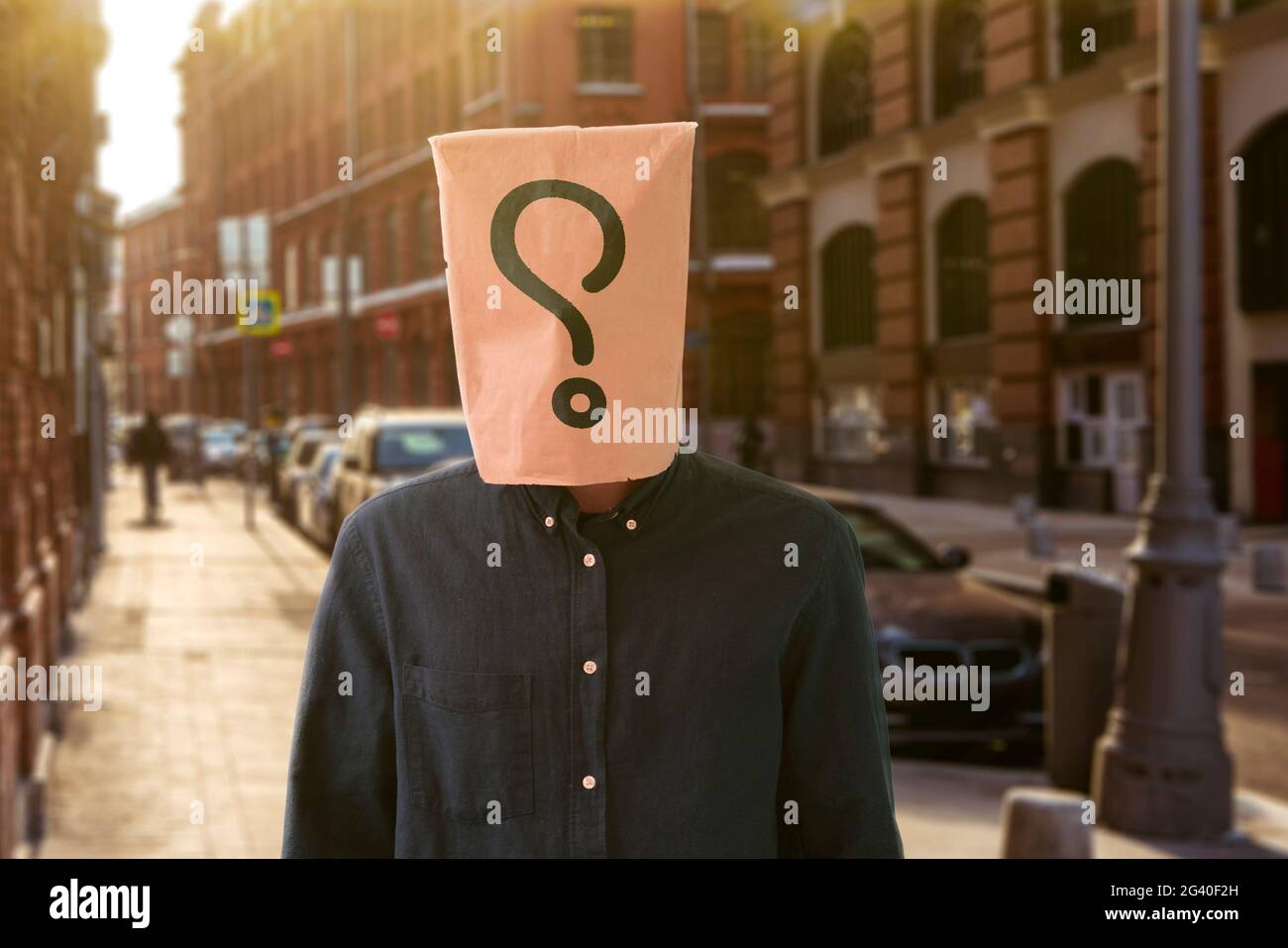 a person with a paper bag on the head with question mark, sign symbol of problem Stock Photo Alamy