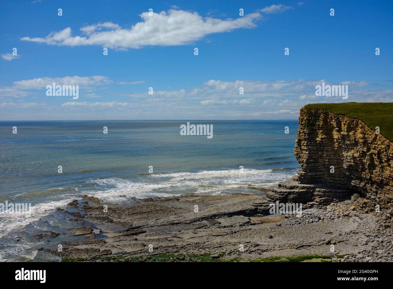 The shelving sea bed and layered cliffs at Nash Point, Wales. Stock Photo