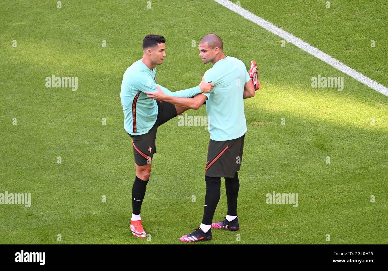 Munich, Germany. 18th June, 2021. Football: European Championship, Group F, final training Portugal before the match against Germany. Portugal's Cristiano Ronaldo (l) and Pepe stretching. Credit: Federico Gambarini/dpa/Alamy Live News Stock Photo