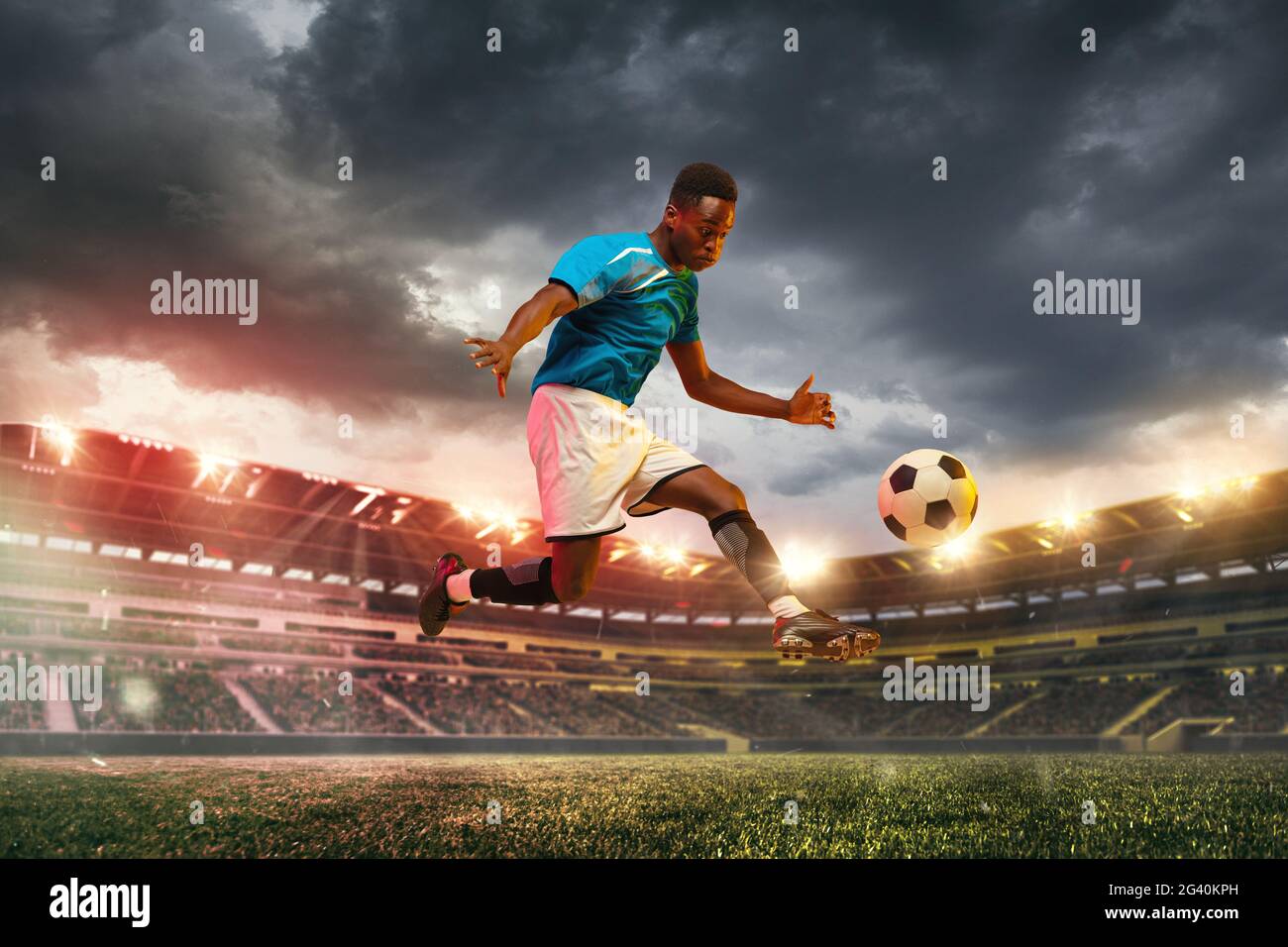 Goal. Male african socce, football player jumping in attack during