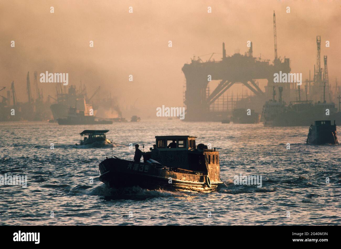 Chinese sampan in Shanghai Harbor under smoggy sky. #284CHINA Stock Photo