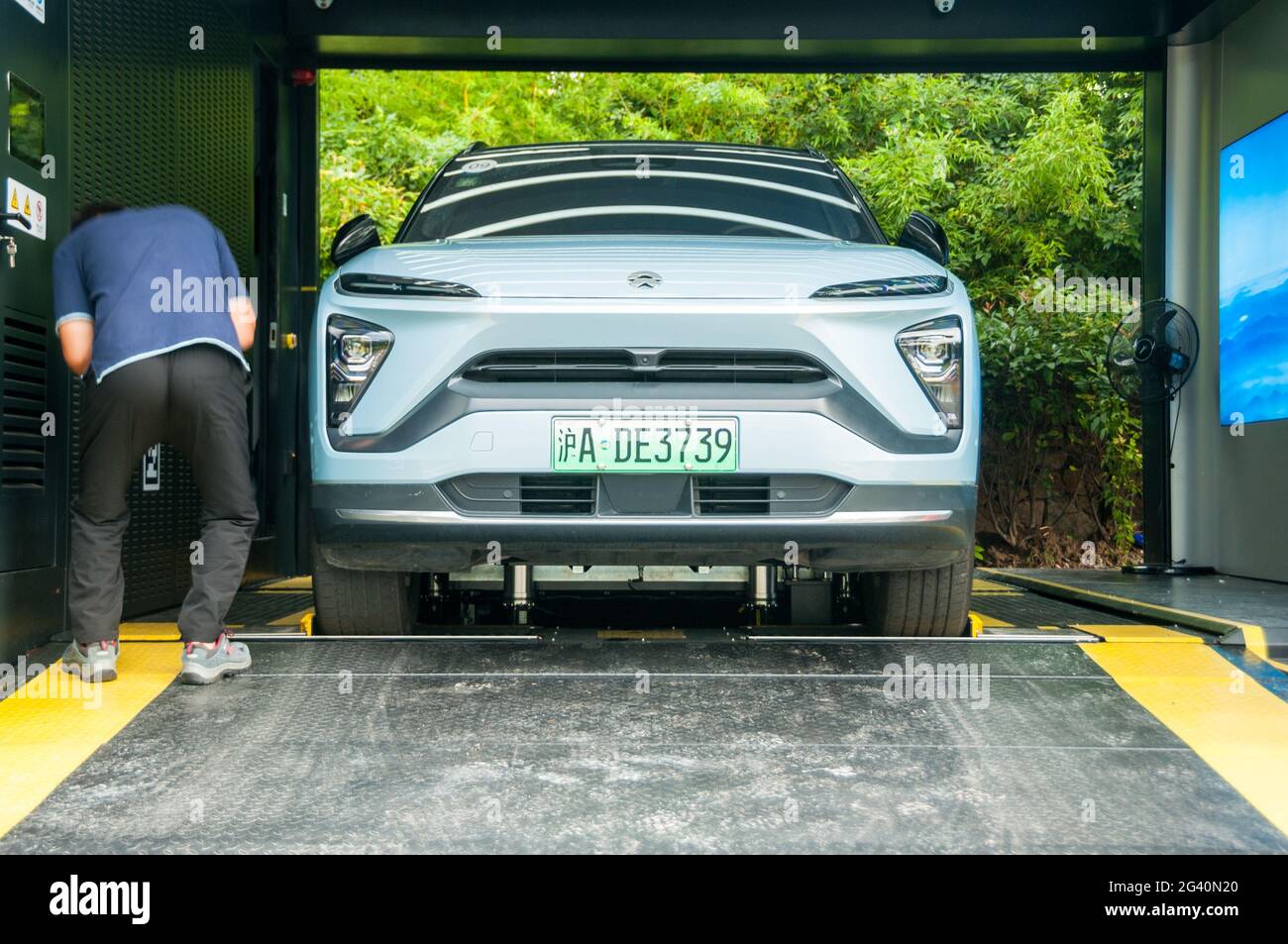 A Nio ES6 at a second generation Nio battery swapping station in the area around Dishui Lake in Pudong, Shanghai, China. Stock Photo