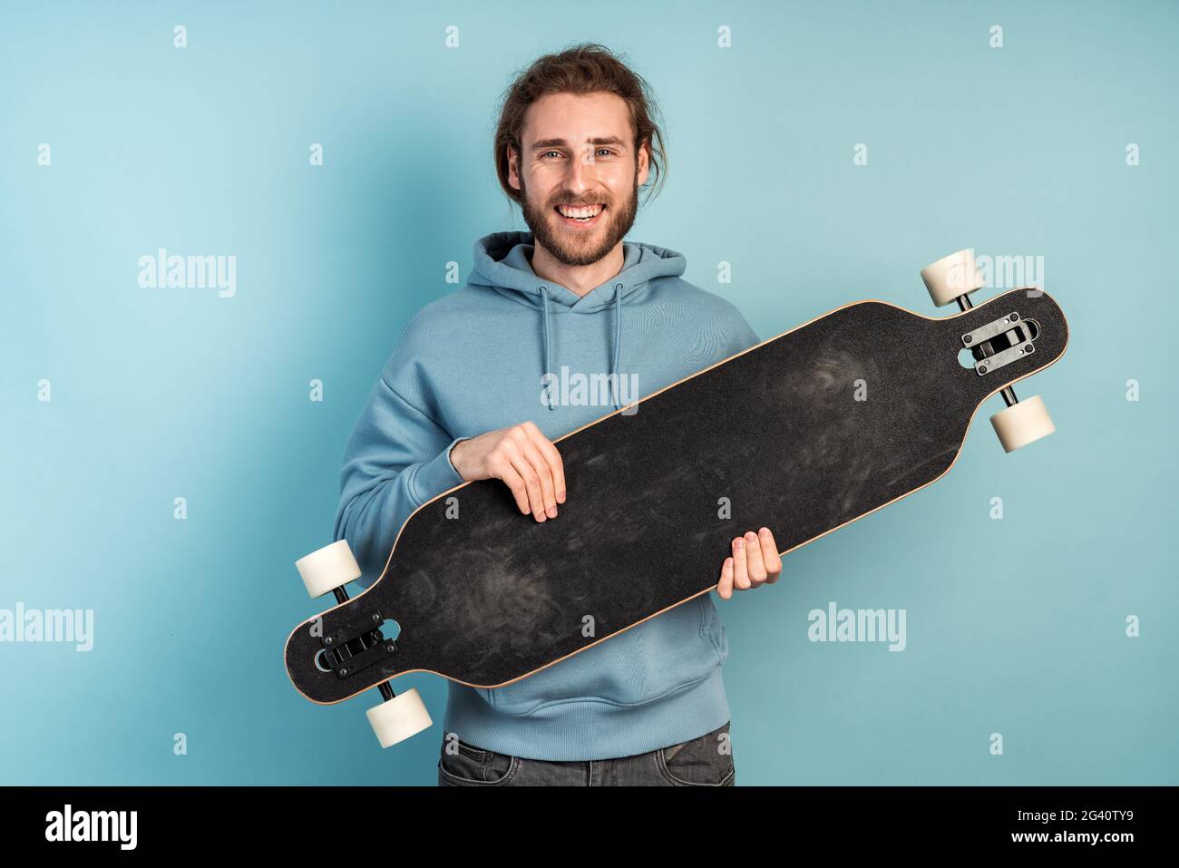 Man holding skateboard in hands hi-res stock photography and images - Alamy