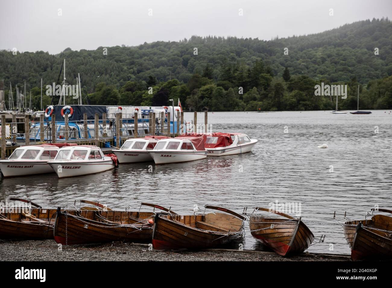 Windermere, Cumbria, England. 16 June 2021. Row boats for hire are seen next to a jetty on Lake