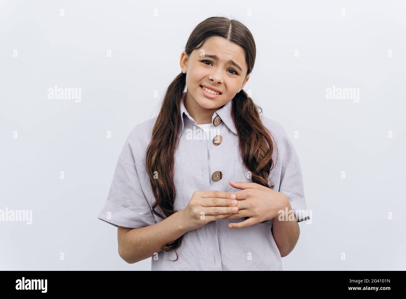embarassed girls Embarrassed teenage girl with long, dark hair on a white background. The  schoolgirl is very ashamed Stock Photo - Alamy