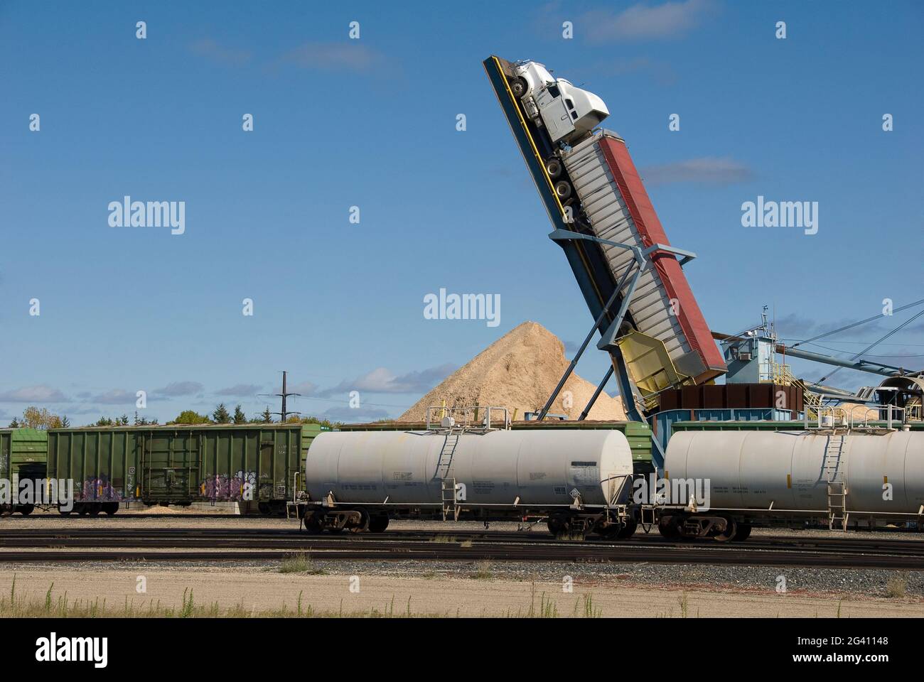 hydraulic lift called a 'truck tipper'  is used to unload wood chips at paper/pulp mill yard - International Falls, Minnesota - USA Stock Photo