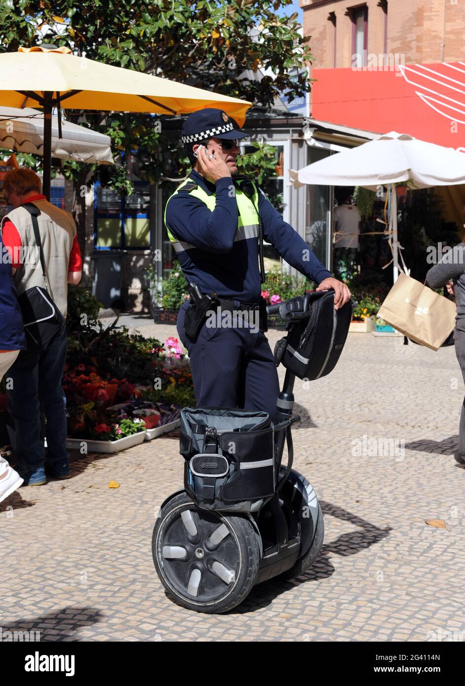 Spanish Police Officer Patrolling on a Segway, Cadiz. The Segway is a two-wheeled, self-balancing personal transporter invented by Dean Kamen. Stock Photo