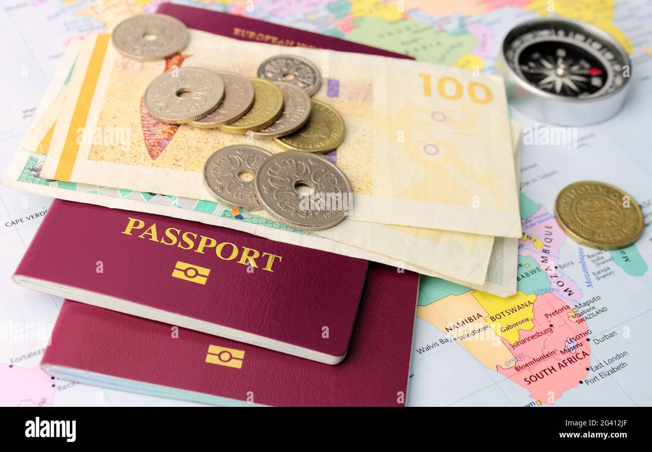 A EU passports on Danish money, with a map and compass to symbolize travel. Stock Photo