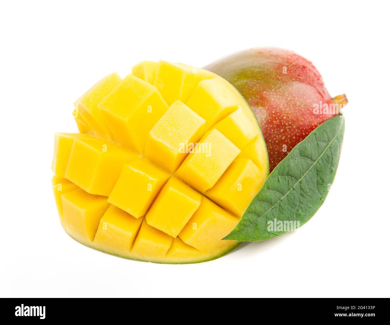 Closeup ripe mango fruit slice with green leaves isolated on white Stock Photo