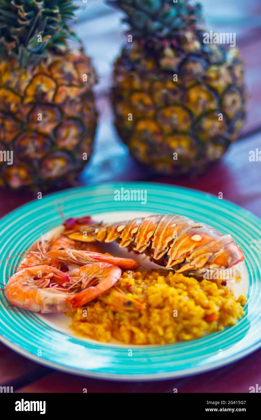 Colourful plate with lobster tail and shrimps in an outdoor restaurant on Cayo Blanco, Cuba Stock Photo