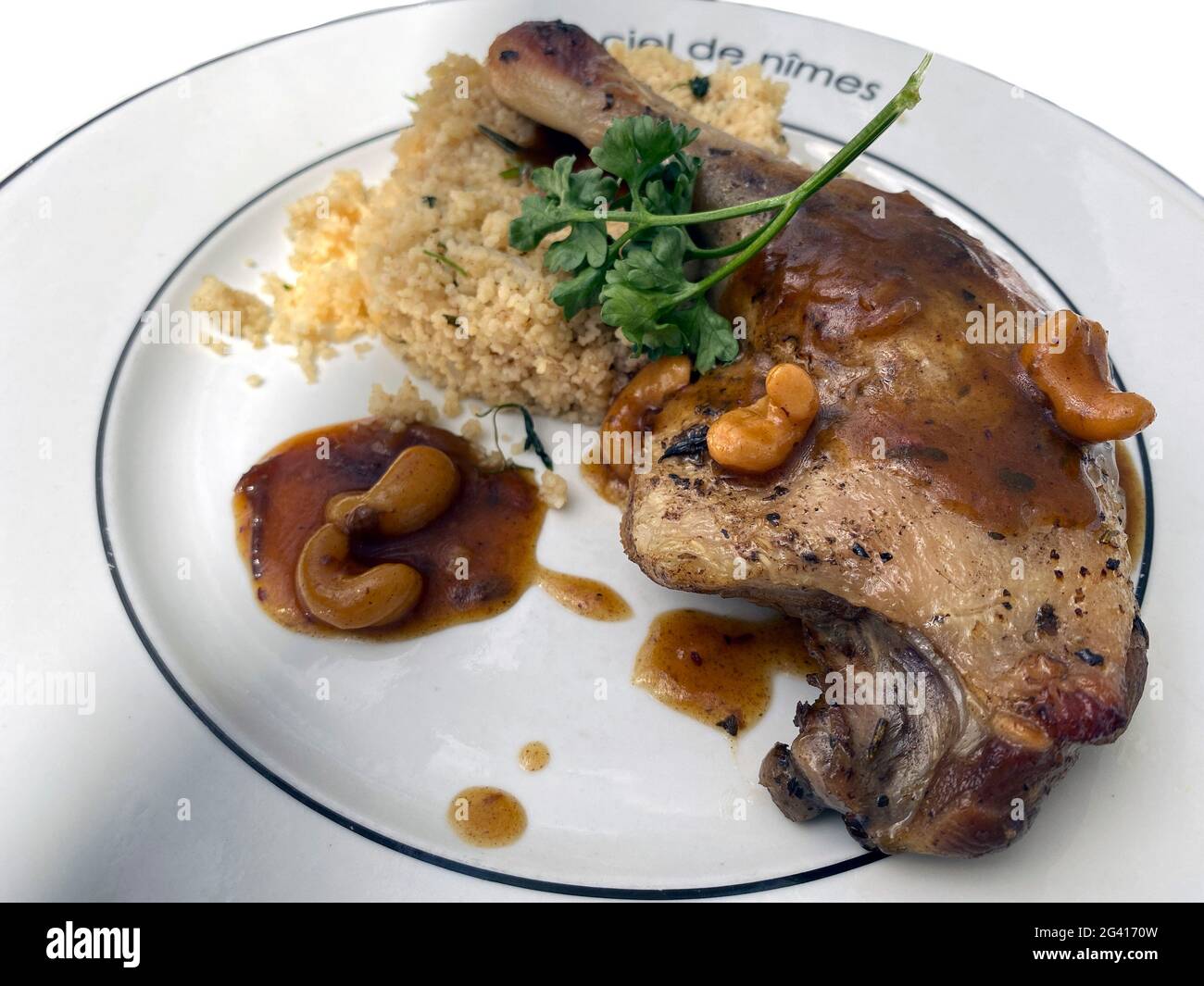 Duck confit with cashew nuts and rice dish in Restaurant Le Carré D´art upstairs of Carré d'Art contempory art museum, Nimes Gard department, Occitani Stock Photo