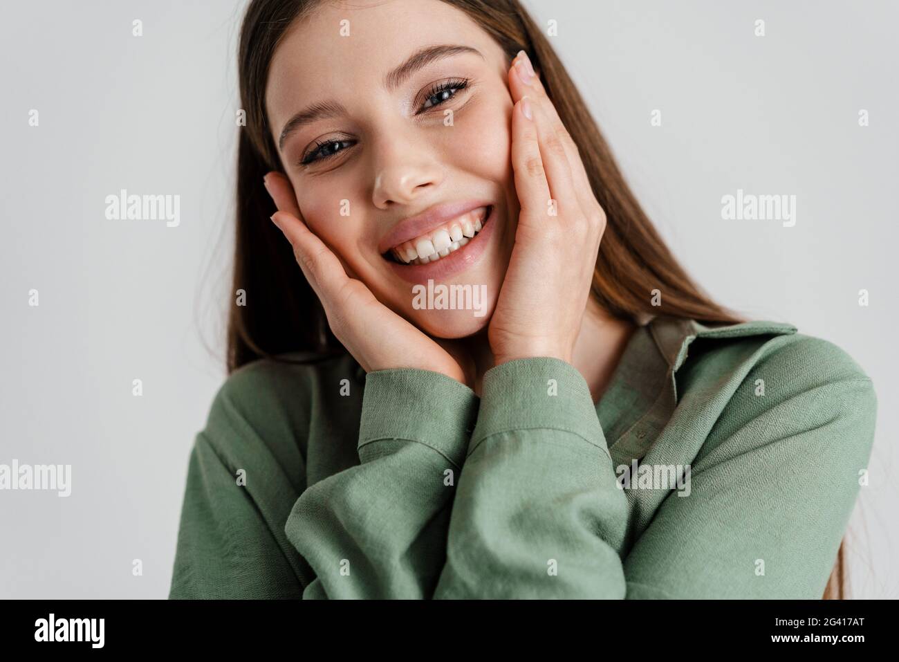 Happy caucasian girl smiling and looking at camera isolated over white ...