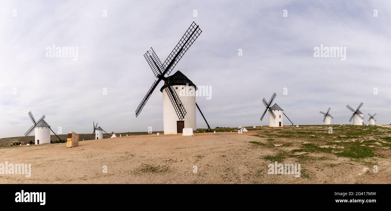 A panorama view of the historic white windmills of La Mancha above the town of Campo de Criptana Stock Photo