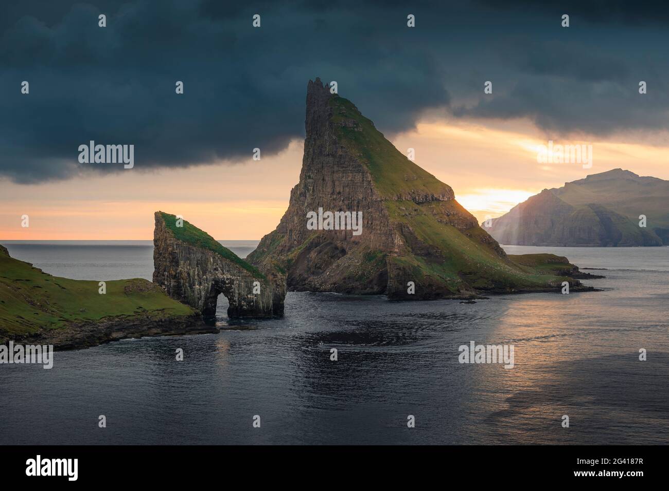 Drangarnier rock formations and Tindholmur island in sunset on Vagar ...