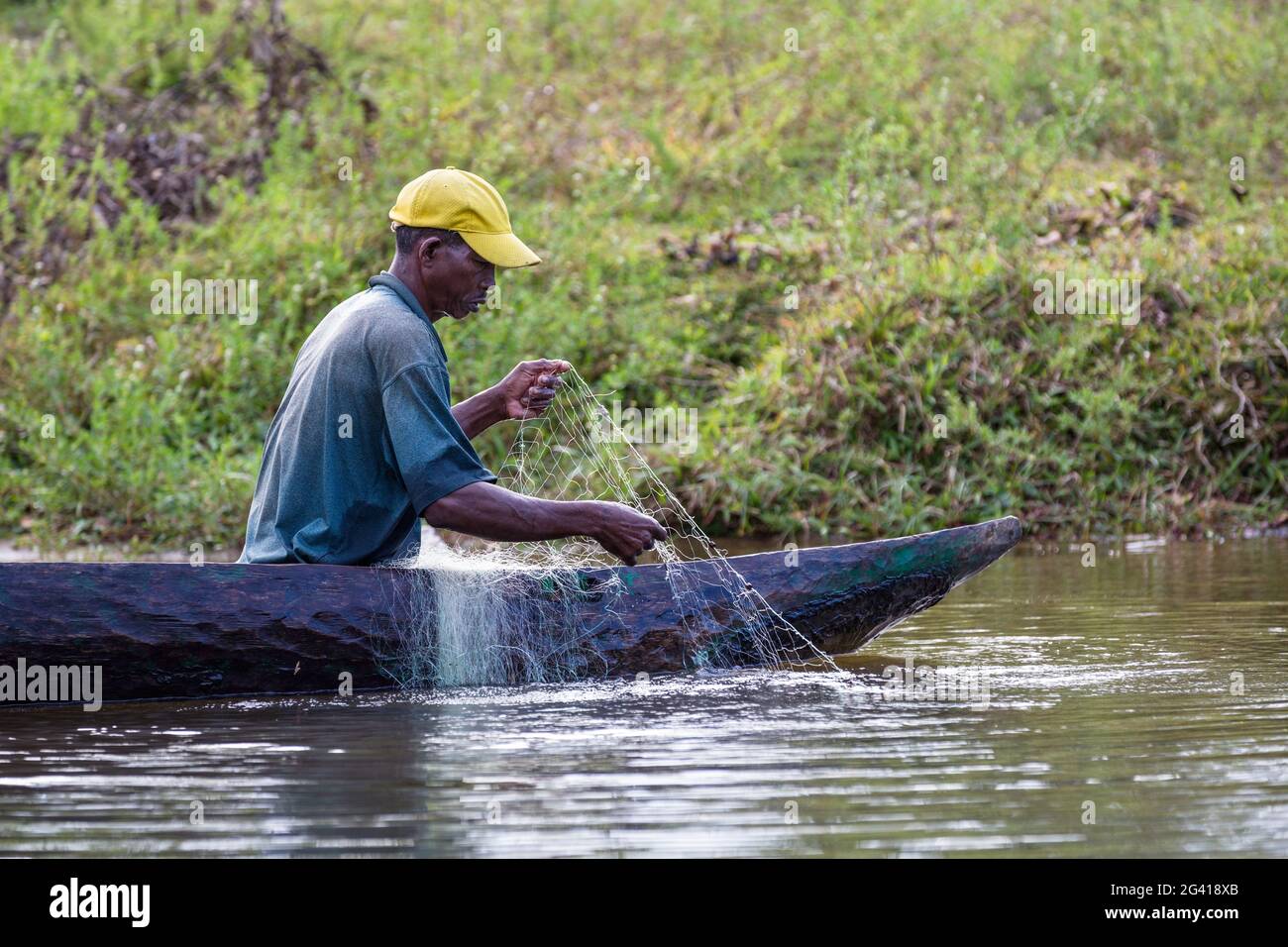 Fisherman in dugout canoe, Pangalanes Canal, Canal de Pangalanes, Eastern Madagascar, Africa Stock Photo