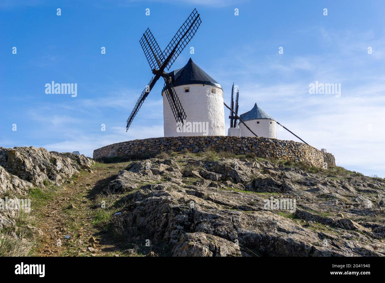 Traditional whitewashed Spanish windmills in La Mancha on a hilltop