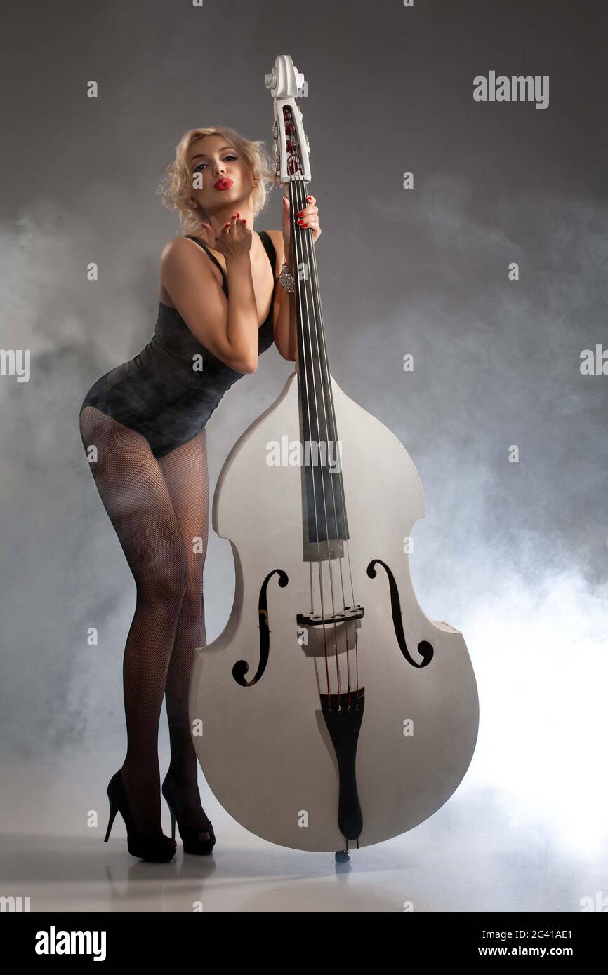 Young Woman In Lingerie With A Double Bass Stock Photo