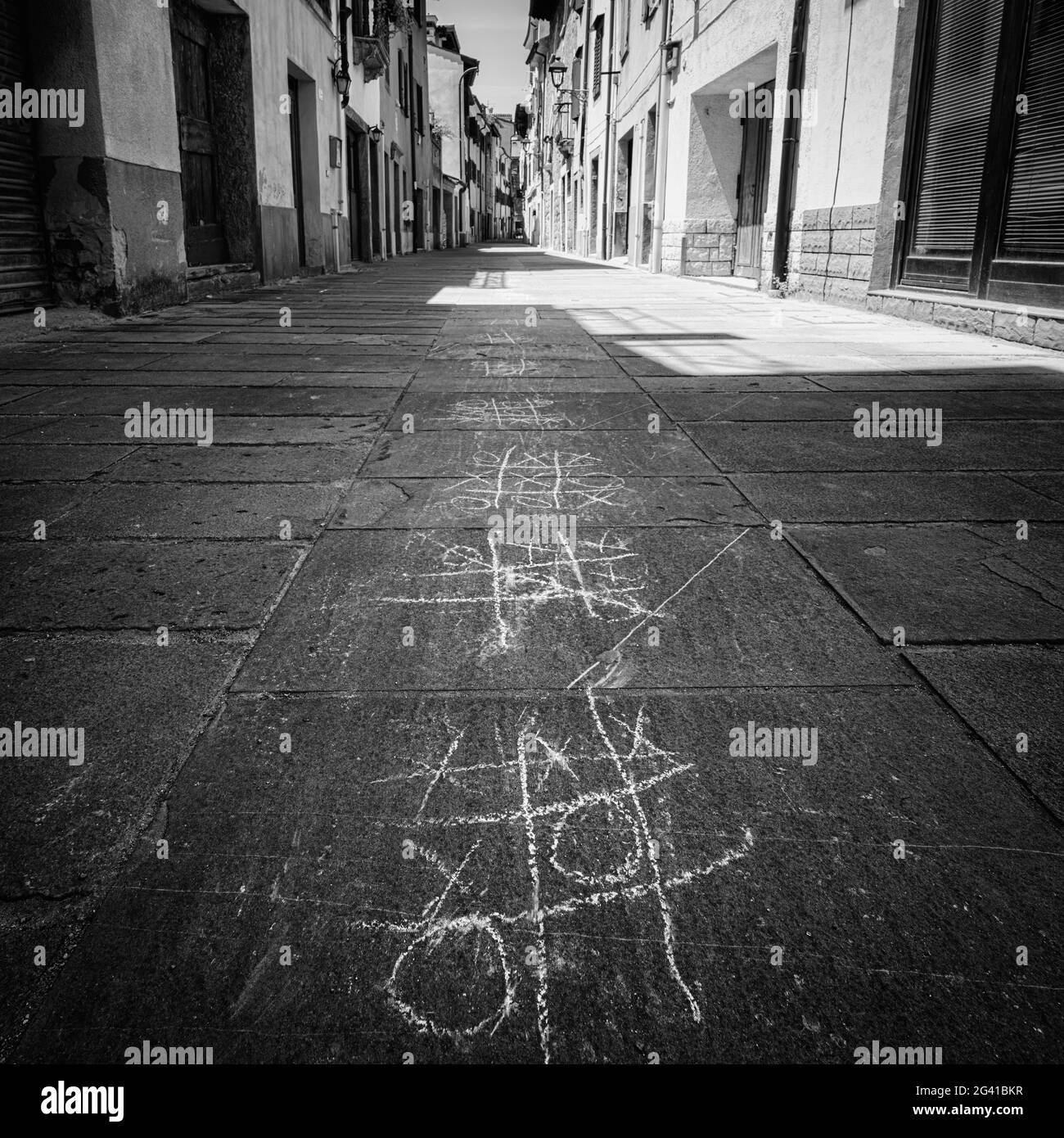Muggia, Italy. June 13, 2021. the tic-tac-toe game drawn with chalk on the pavement of a narrow street in the town center Stock Photo
