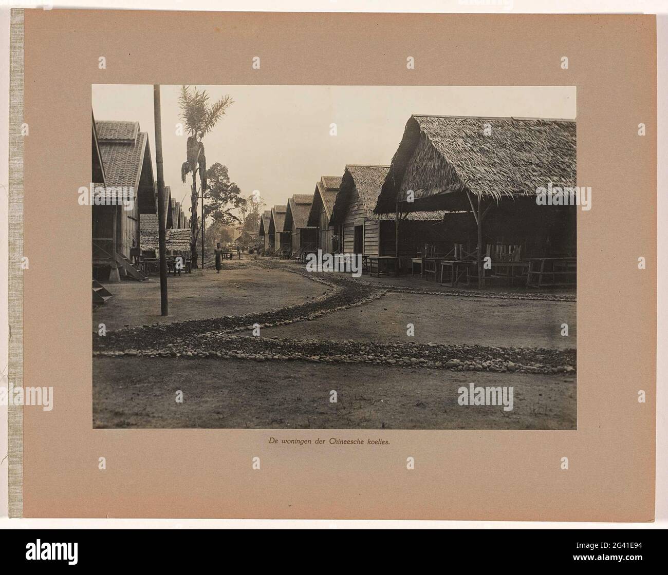 The houses of Chinese coolies. Street with the houses of the Chinese workers working at the mine. Part of the loose-leaf photo album offered by the staff of the Boekit-ASAM coal mines on Sumatra on the separating engineer director H. Tromp on January 7, 1922. Stock Photo