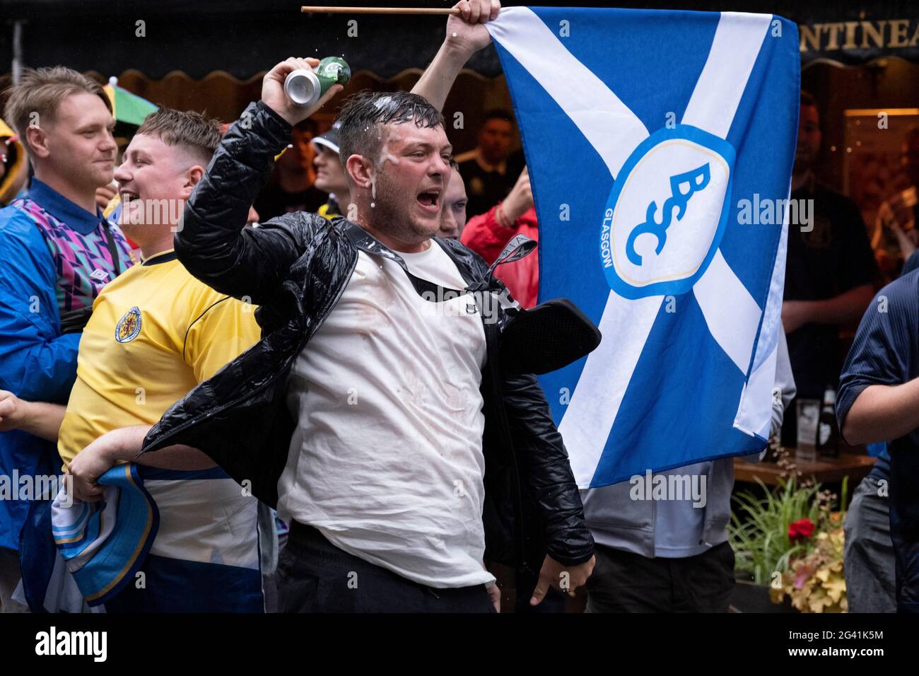 Scotland football supporters gather in the rain near London's Leicester  Square before tonight's match between England and Scotland at Wembley,  during the European Championships (postponed for a year because of the Covid