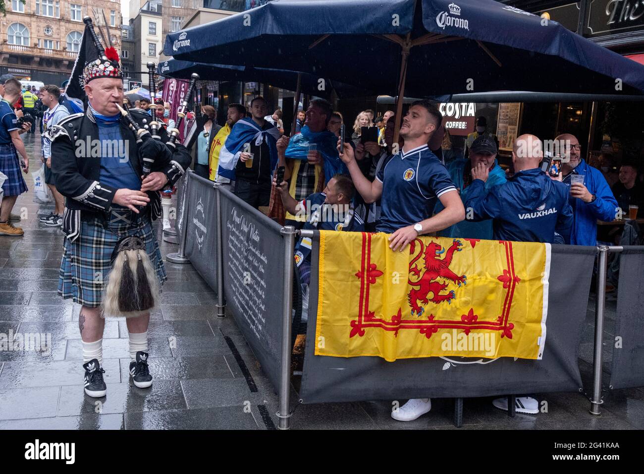 Scotland football supporters gather in the rain near London's Leicester Square before tonight's match between England and Scotland at Wembley, during the European Championships (postponed for a year because of the Covid pandemic), on 18th June 2021, in London, England. The two nations have traditionally been fierce sporting rivals and this is the first time that Scotland has qualified for the 'Euros' for 23 years. Stock Photo