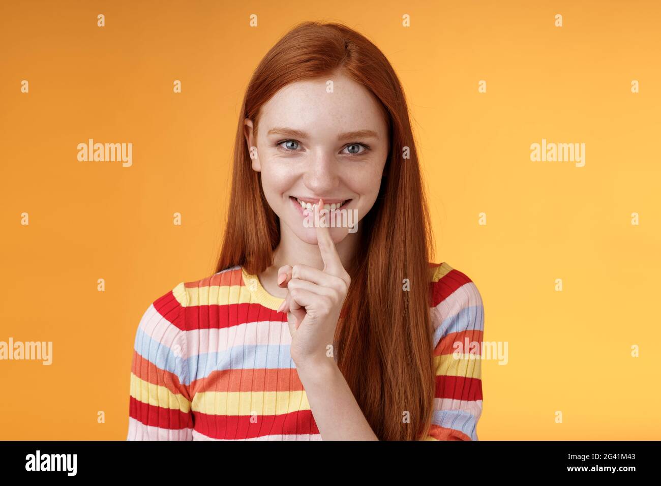 Flirty devious creative young redhead smiling excited ginger girl prepare mysterious gift surprise party giggling tricky say shu Stock Photo