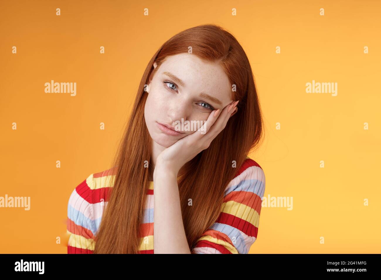 Indifferent careless sleepy redhead silly female student lean palm looking bored uninterested listen lame stories wanna escape s Stock Photo