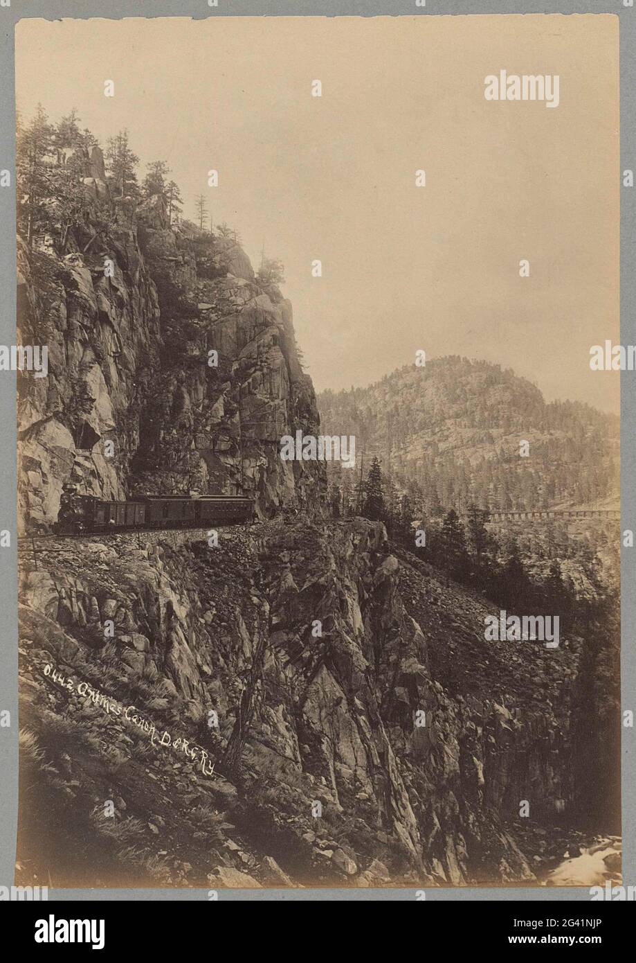 Train from the D. & R.G.RY in the Animas Canyon in Colorado with a railway via duct on the right; Animas Canon, D. & R.G.RY. . Stock Photo