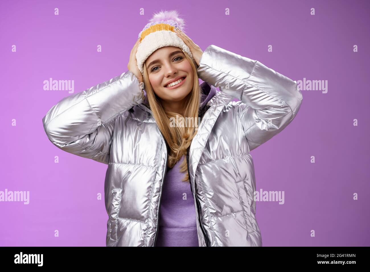 Tender romantic attractive blond female enjoying winter ski resort vacation having fun look pleased smiling broadly tilting head Stock Photo