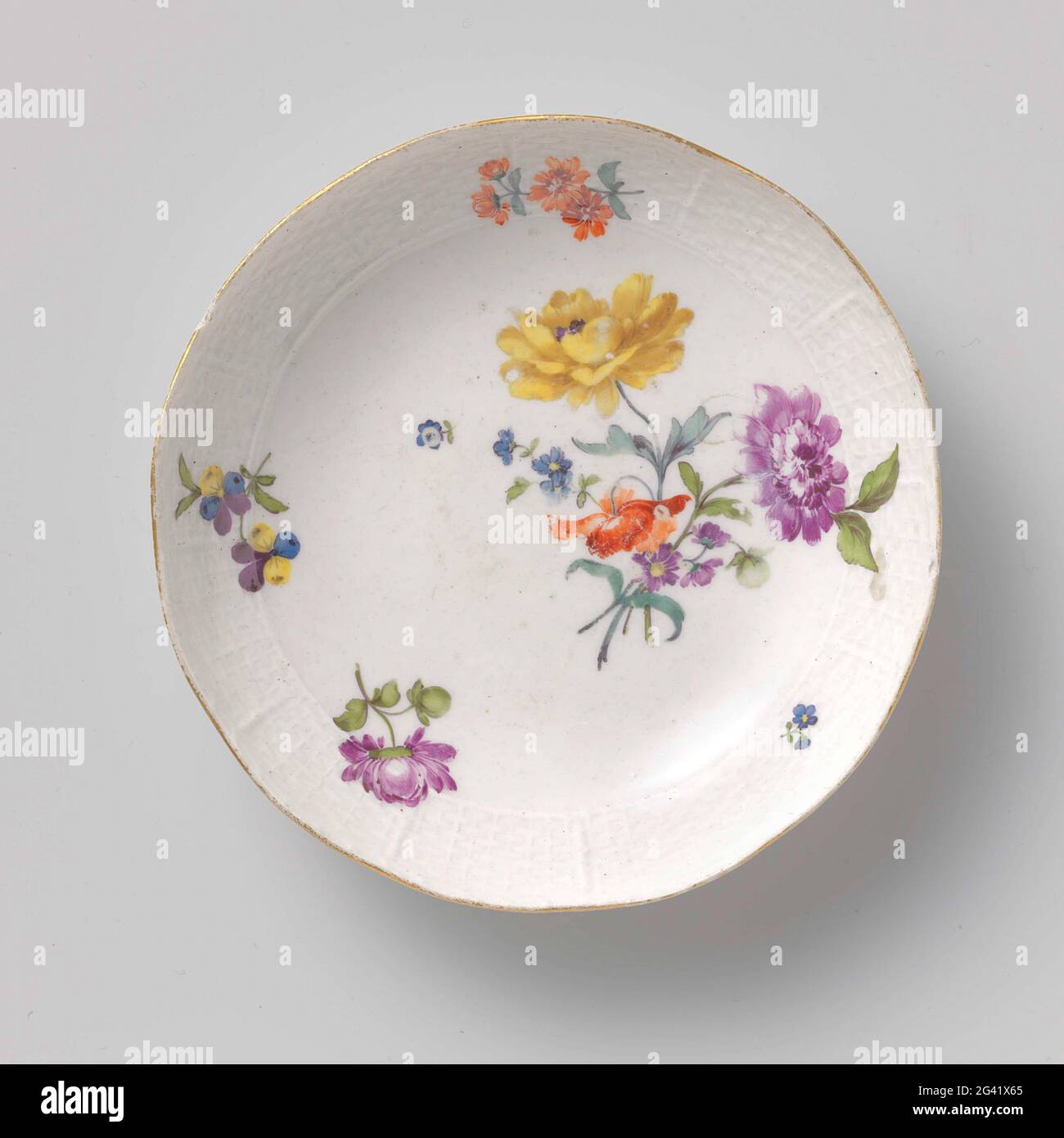 Dish, painted multicolored with flower bouquets. Round dish of painted porcelain. The dish is painted with flower bouquets and decorated with a Ozier edge. The dish has been marked. Stock Photo