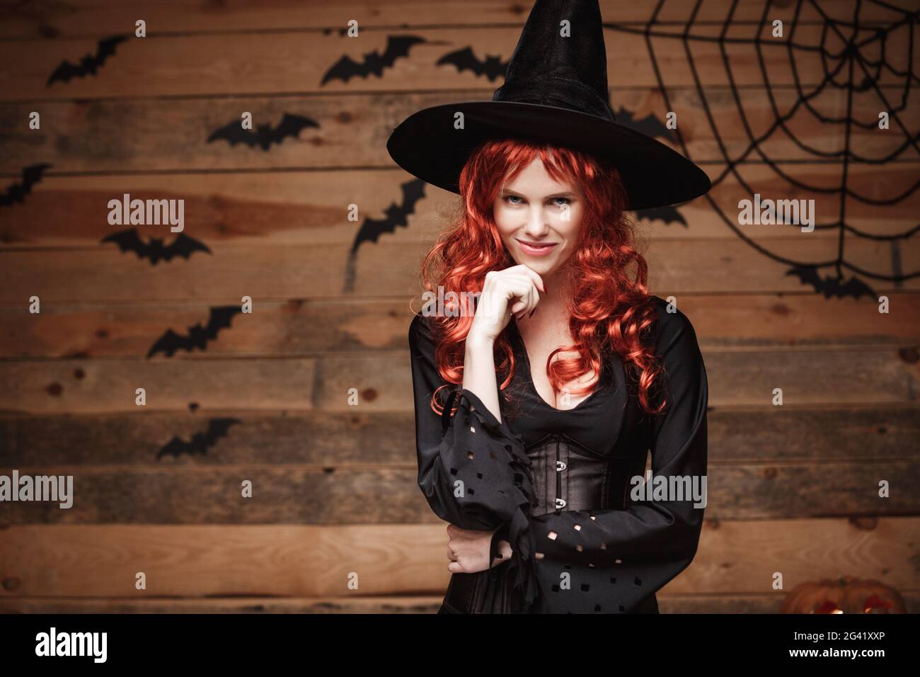 Halloween witch concept Happy Halloween red hair Witch holding hand