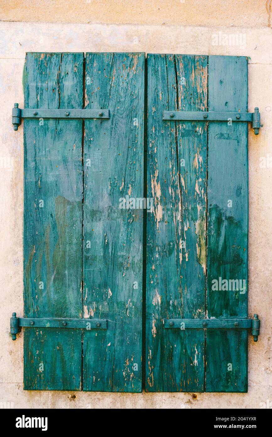 Old closed green wooden shutters with peeled paint Stock Photo - Alamy