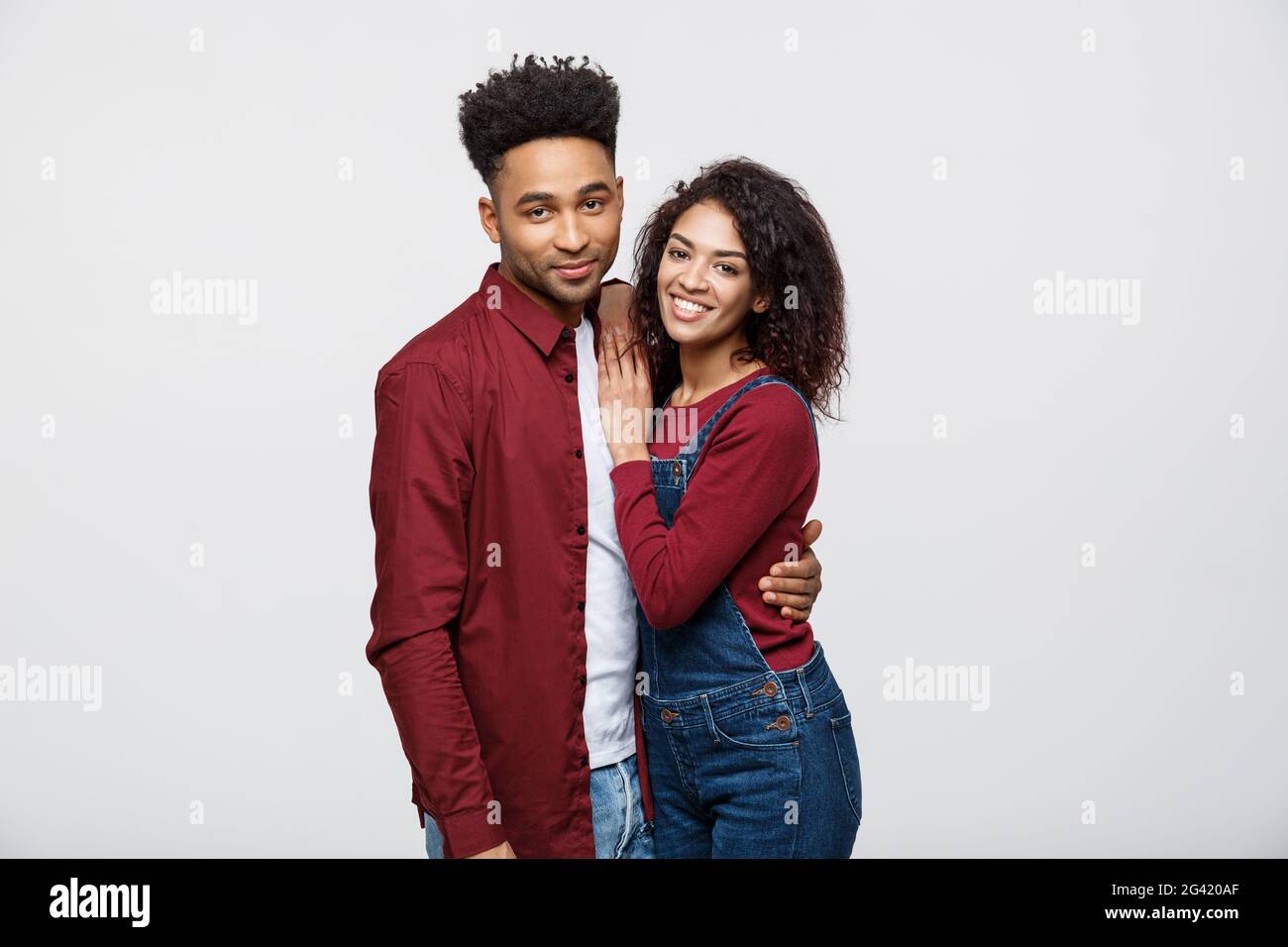 Portrait of happy african american couple hug each other on white ...