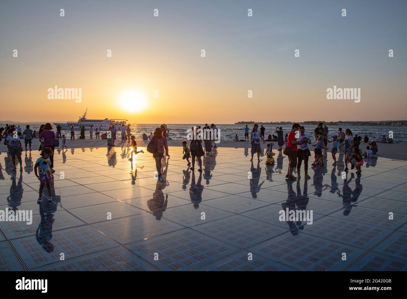People gather on the magnificent monument to the sun at sunset, Zadar, Zadar, Croatia, Europe Stock Photo