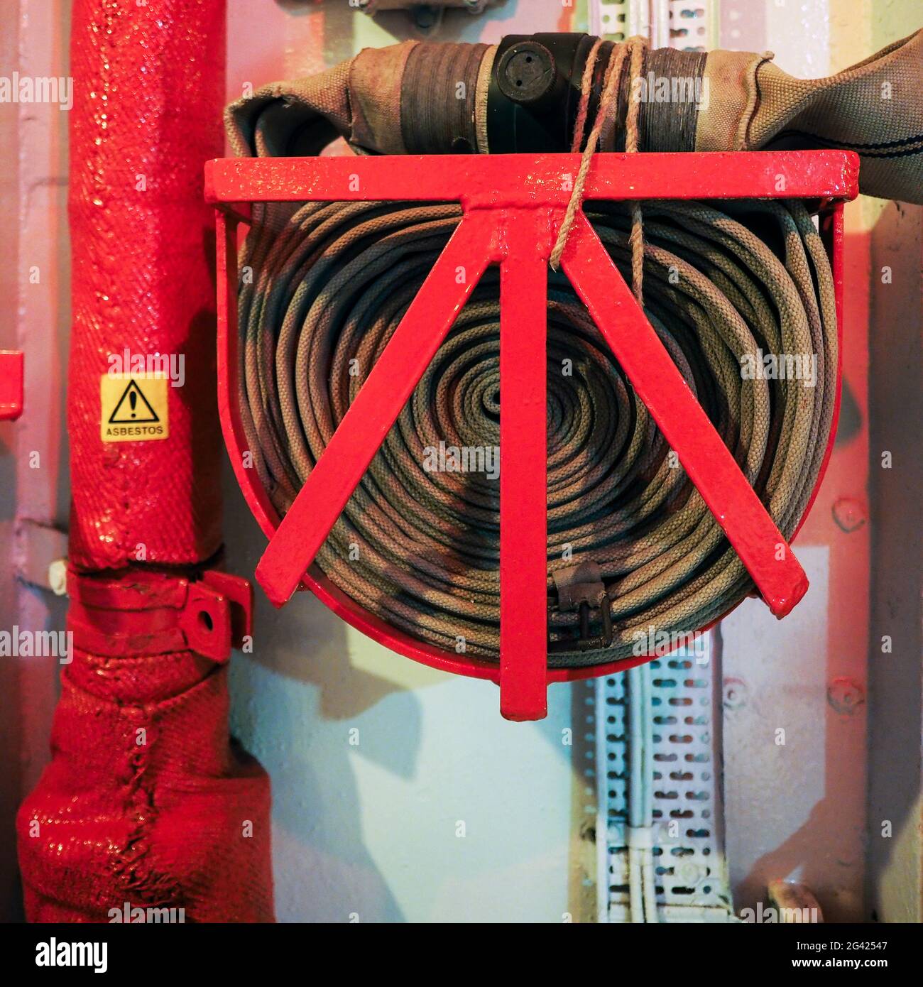 Fire extinguisher and fire hose reel hanging on the wall in building,  safety concept Stock Photo - Alamy