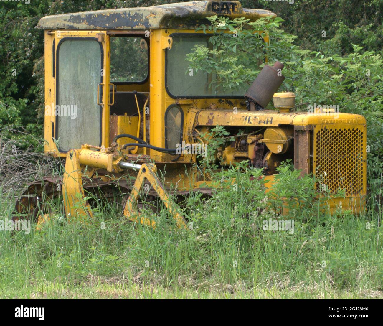 Retired Caterpillar Farm vehicle, parked up in a field. Stock Photo