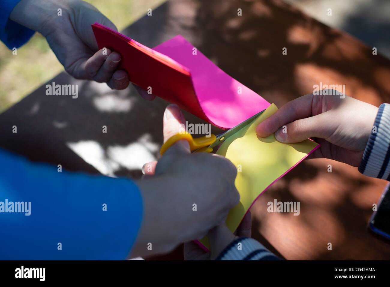 Cutting colored paper. Scissors cut the paper. Creativity with children