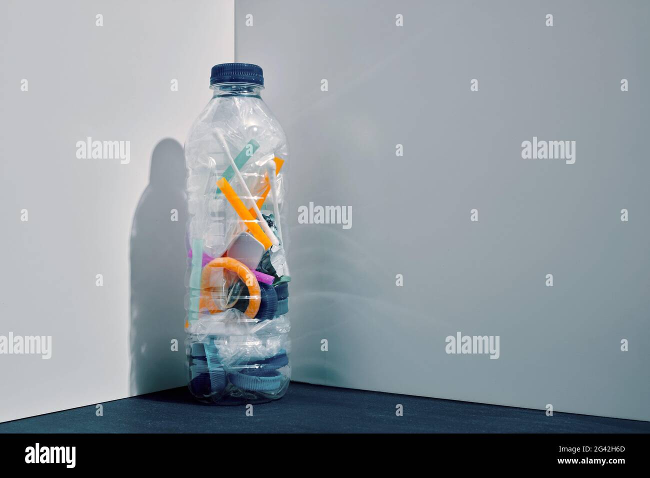 Pile of plastic objects in a plastic drinking water bottle