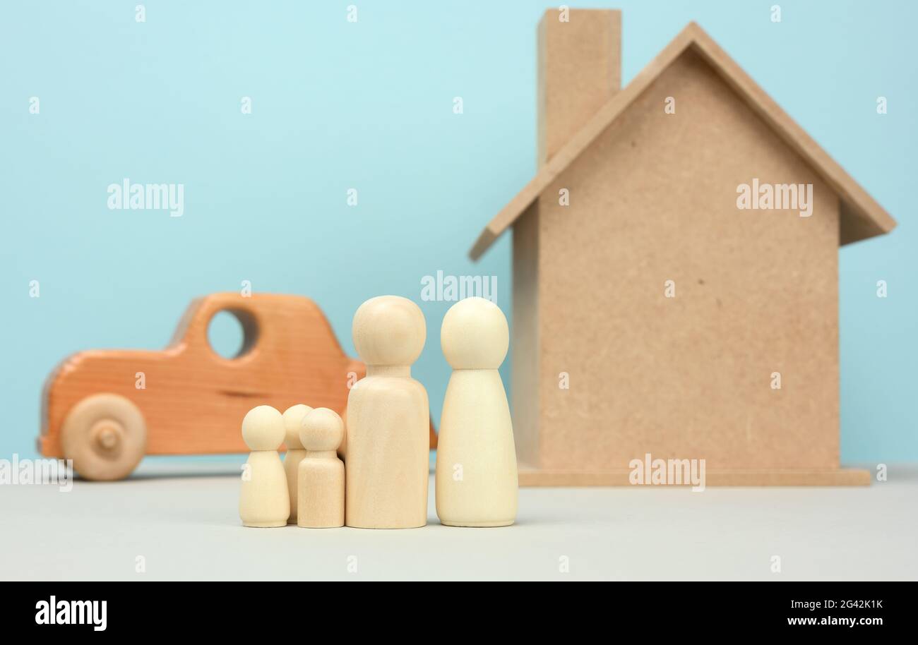 Wooden house and car with miniature family figures, mortgage and loan concept Stock Photo