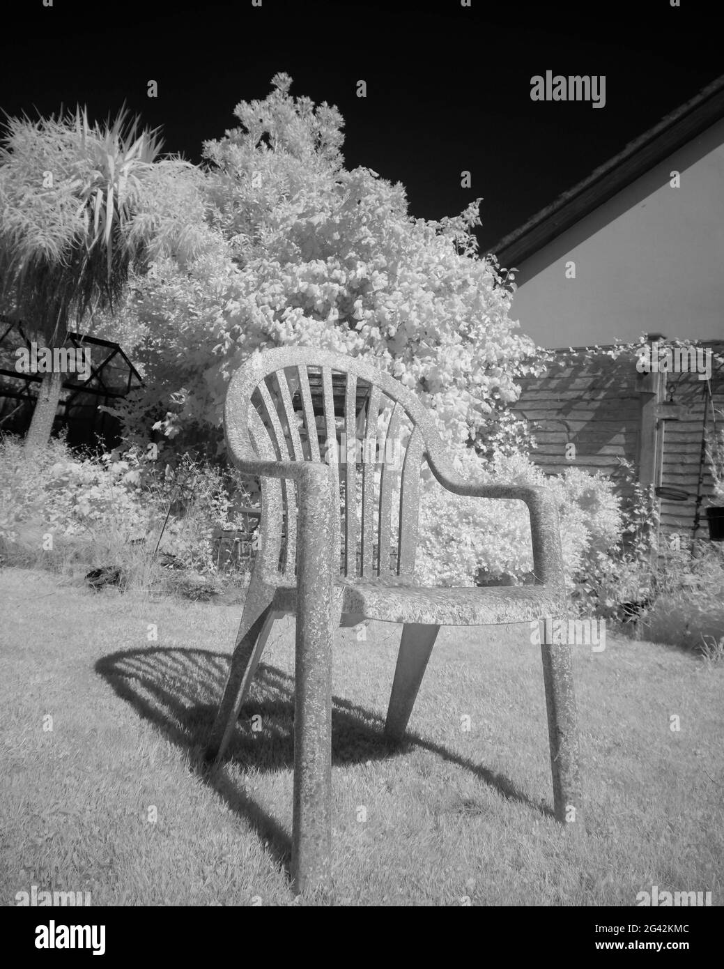 June 2021 - An old garden plastic chair taken on infrared Stock Photo