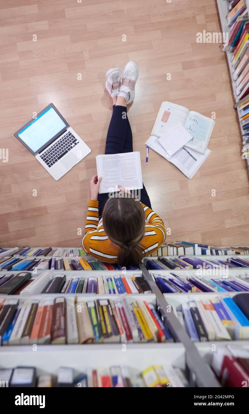Student Using Notebook Paper The student uses a notebook and a school library Stock Photo - Alamy