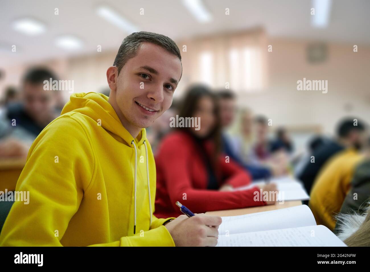 Student taking notes while studying in high school Stock Photo