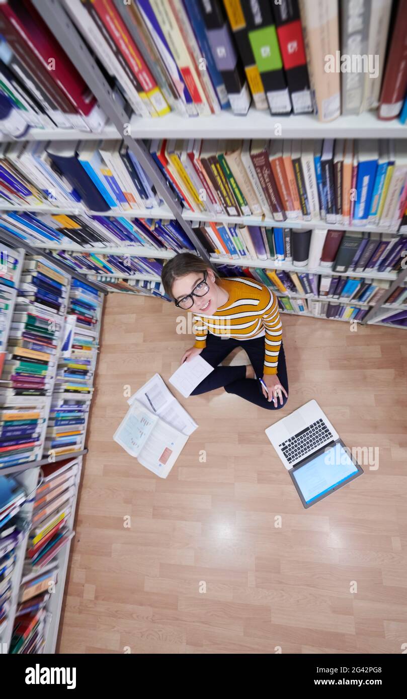 Student Using Notebook Paper The student uses a notebook and a school library Stock Photo - Alamy