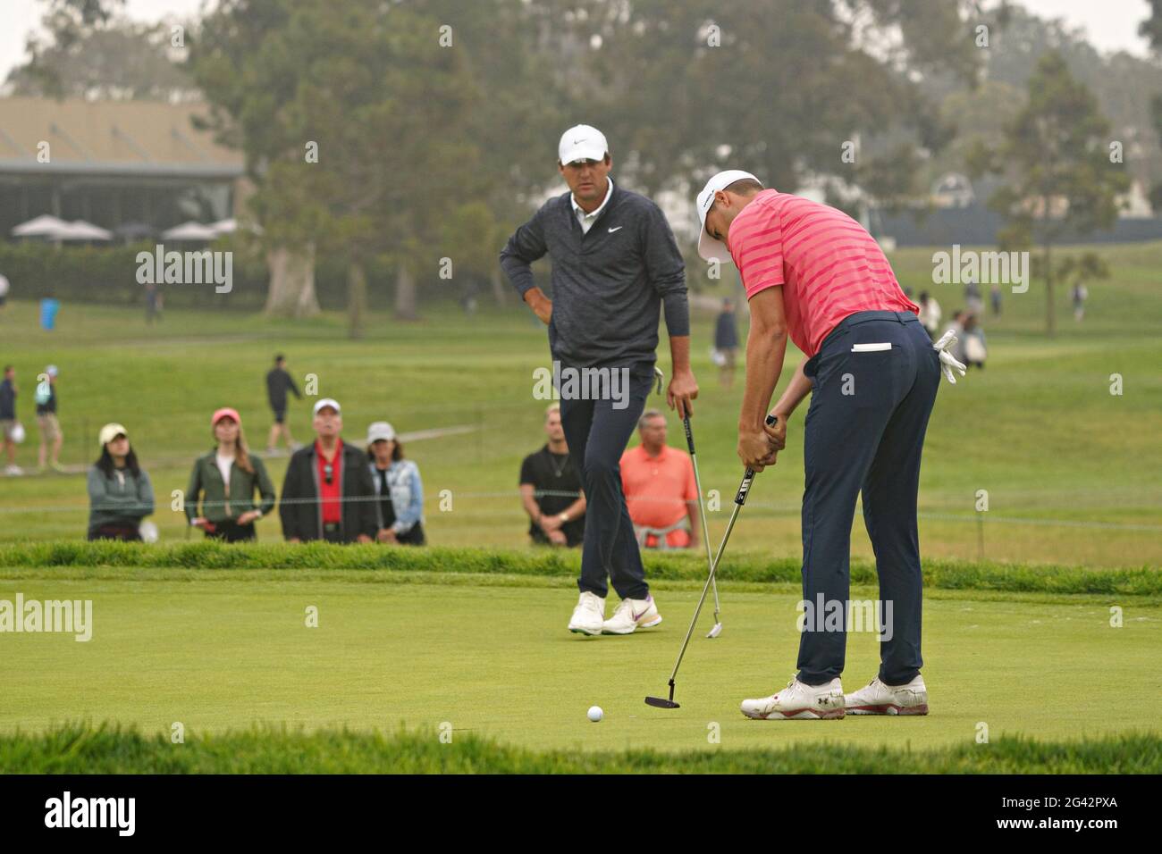 San Diego, USA. 18th June, 2021. Scottie Scheffler watches Jordan Spieth hit a putt on the sixth hole during the second round at the 121st US Open Championship at Torrey Pines Golf Course in San Diego, California on Friday, June 18, 2021. Photo by Richard Ellis/UPI Credit: UPI/Alamy Live News Stock Photo