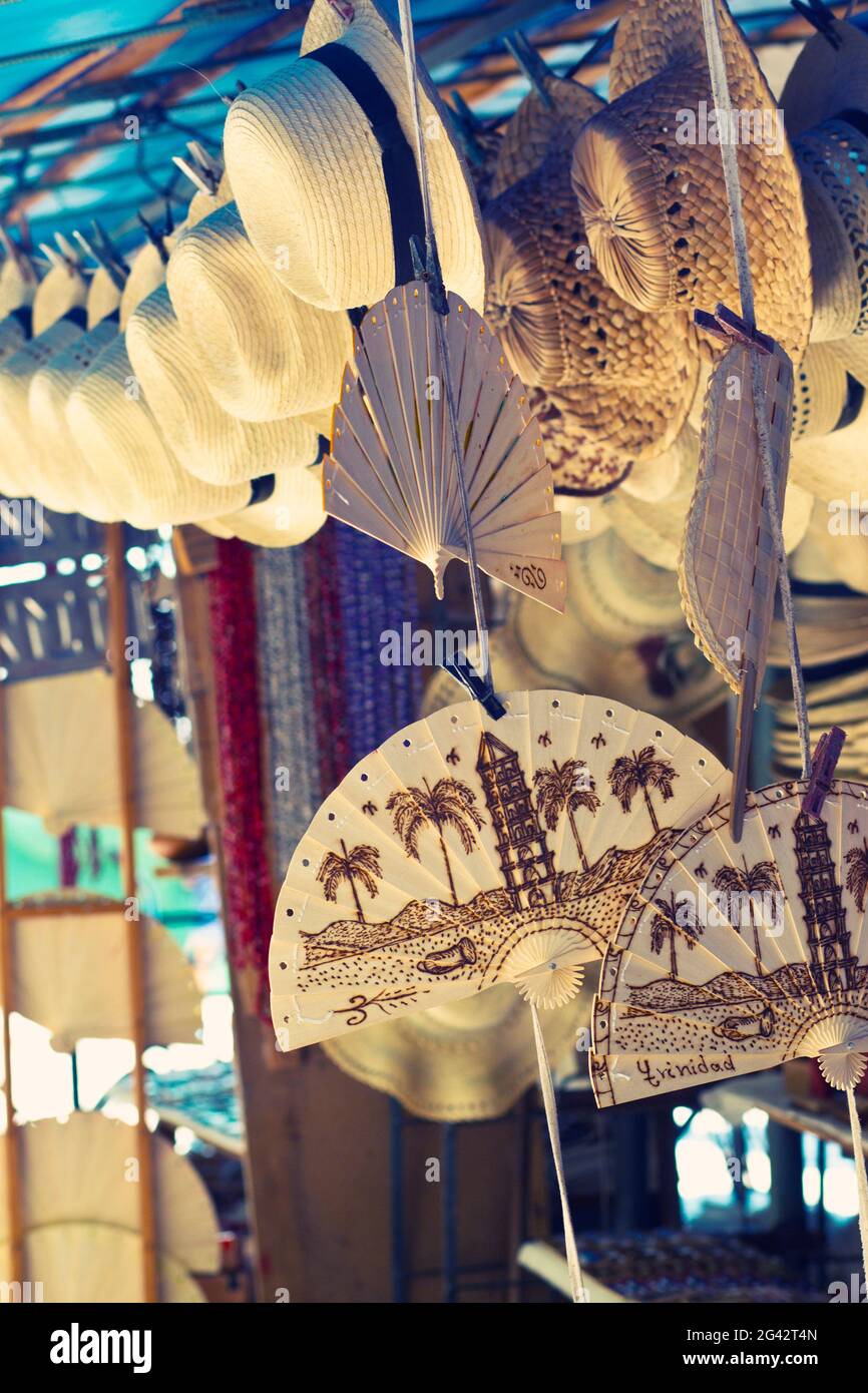 Straw hats and wooden fans on the market in Trinidad, Cuba Stock Photo