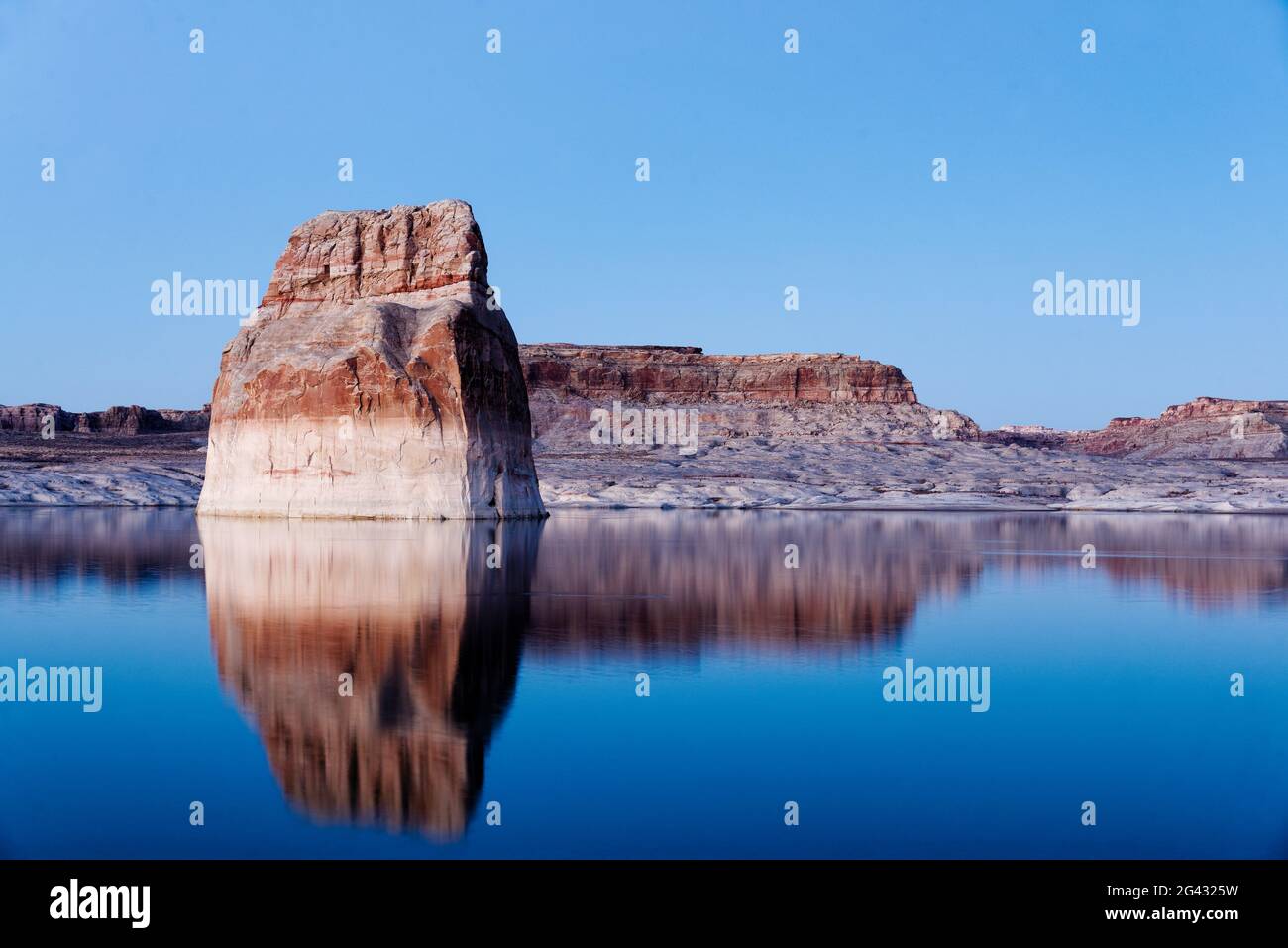 Sandstone rock formation reflecting in lake, Utah, USA Stock Photo