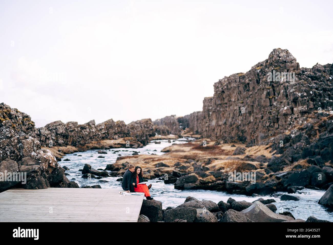 Boy girl sitting on bridge hi-res stock photography and images - Alamy