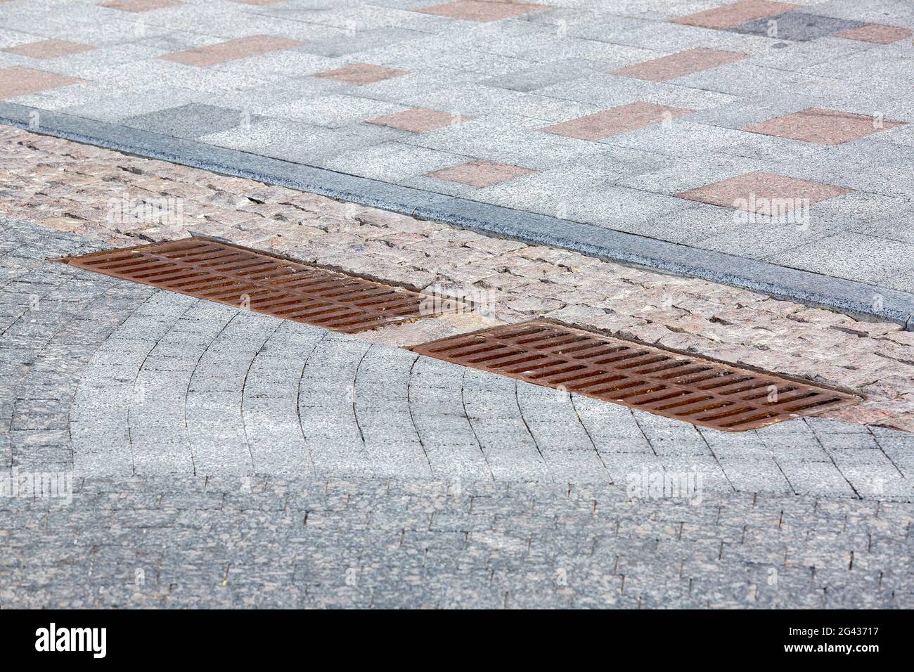 2 rusty iron hatch rectangular grating of the drainage system on the