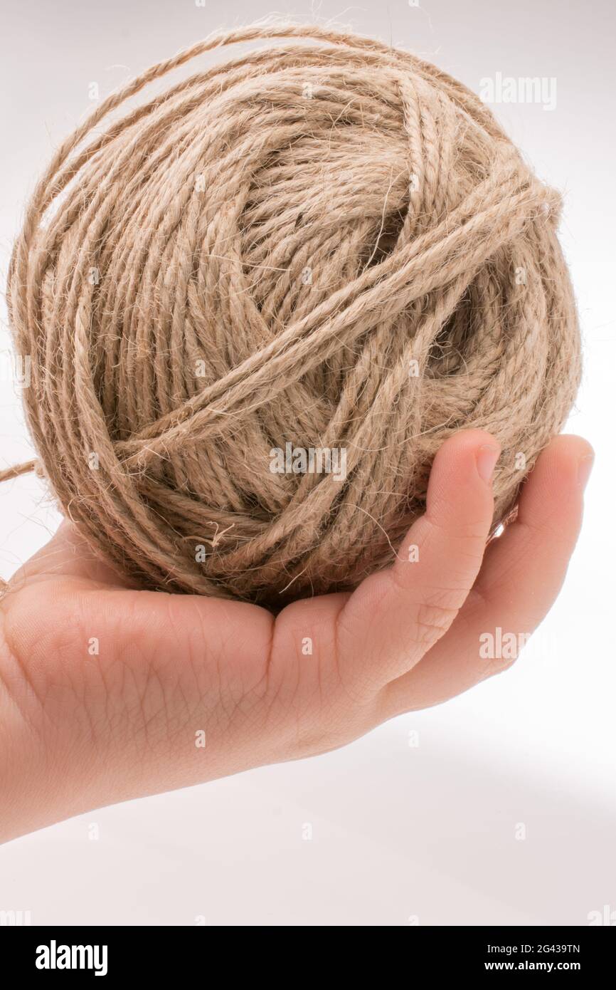 Spools of thread in hand isolated on white background Stock Photo